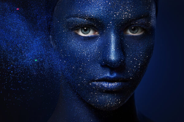 Beautiful,Girl,Face,Painted,With,Blue,Paint,With,Glitter.,The